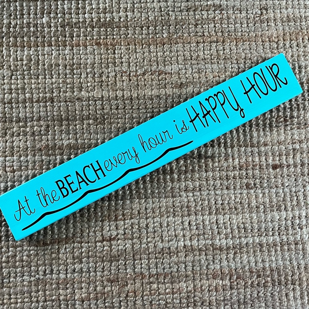Sign, ‘At the Beach, every hour is HAPPY HOUR’